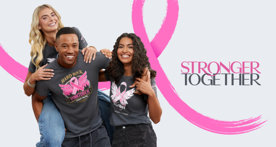 Models wearing Hard Rock Pinktober graphic T-shirts with a pink ribbon backdrop